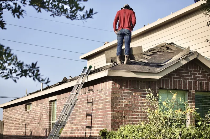 Professional roofer working on a residential roof in Carol Stream